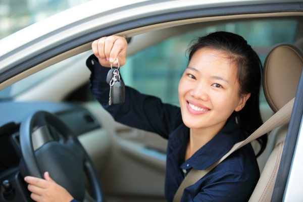 Young driver holding keys