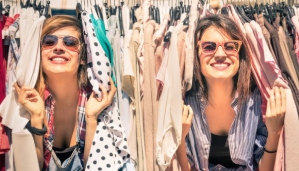 Young beautiful women shopping at the weekly cloth market