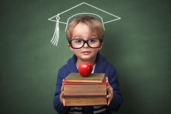 little boy student in front of chalkboard