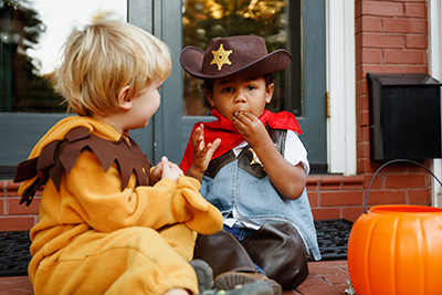 kids eating halloween candy on front porch
