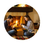 couple sitting by fireplace