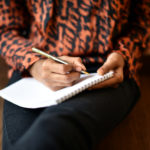 Girl writing on Notepad