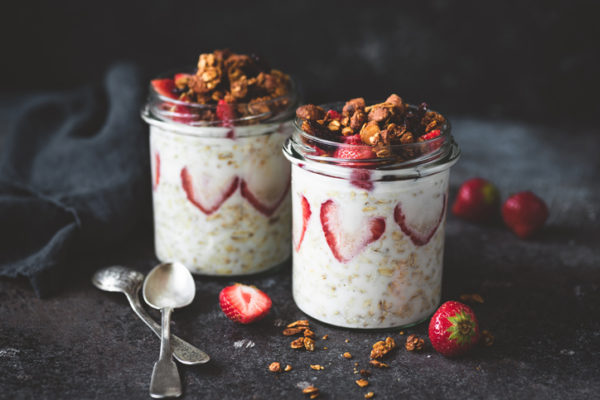 Overnight oats with strawberries and granola in jar. Healthy breakfast, dessert or low fat snack