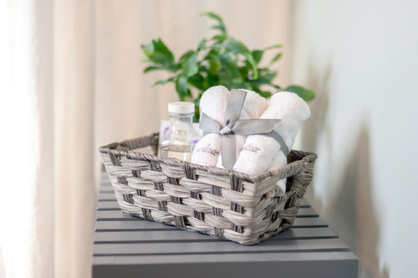 Closeup of basket of bath products beside the bathtub - home spa