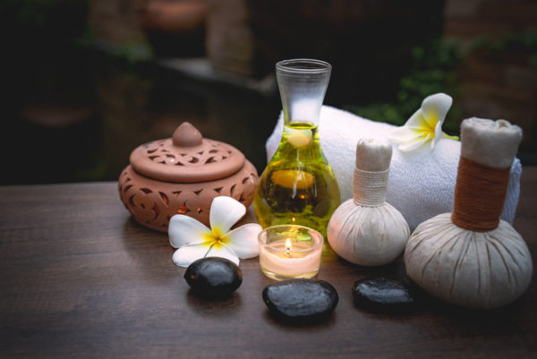 Spa still life with white orchid,sea salt,bath oil and candle on wooden floor,relaxing concept.