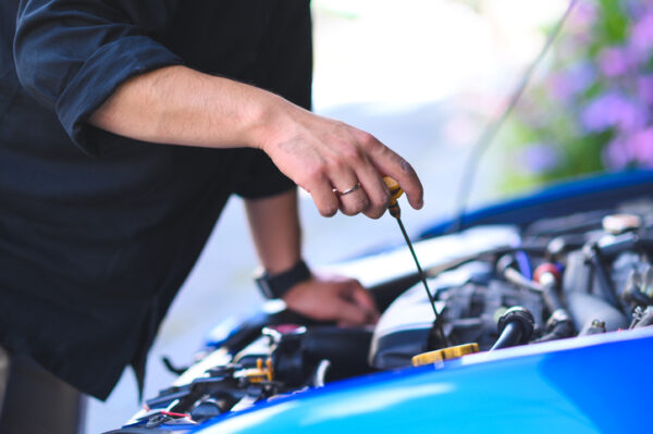 Cropped Hands Of Mechanic maintain car, engine oil check and replace