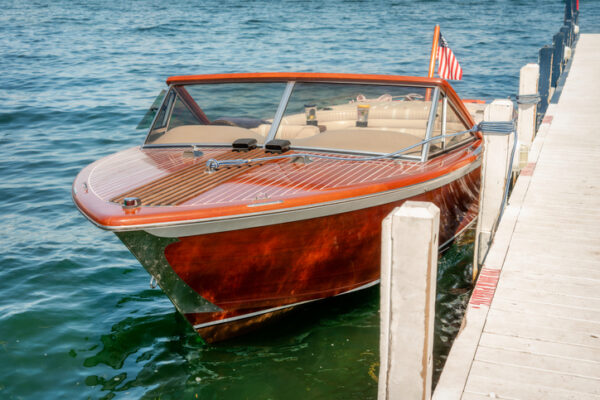 A wooden boat docked at a public pier located in Fontana, Lake Geneva, Walworth County, Wisconsin, USA.