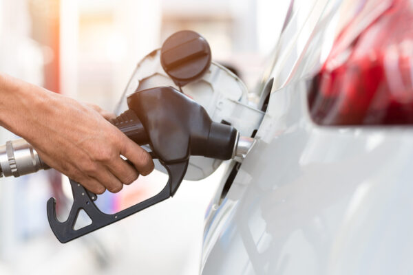 Hand refilling the car with fuel, close-up, Pumping equipment gas at gas station.