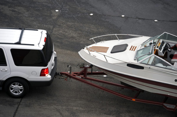 An suv tows a boat