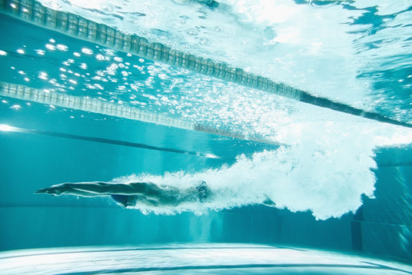 Swimmer underwater after the jump