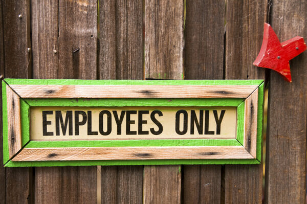 Wooden sign with the words Employees Only.