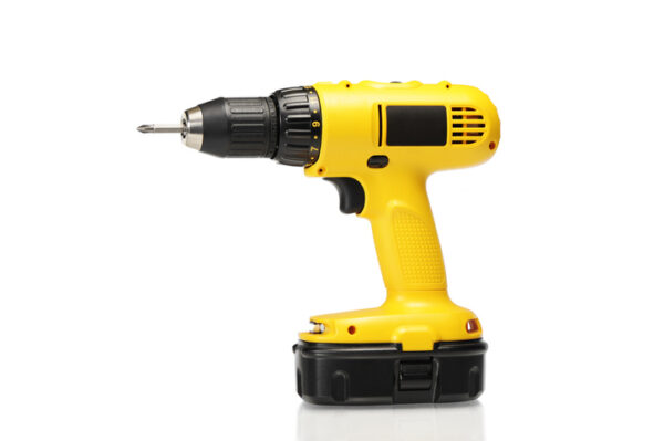Yellow cordless power drill or screwdriver isolated on white. Other picture...