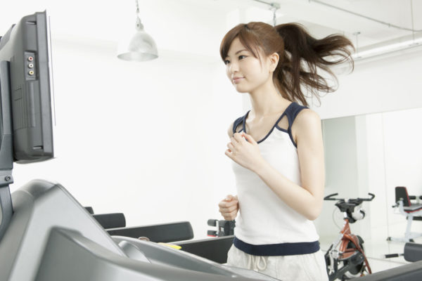 Woman runs on treadmill