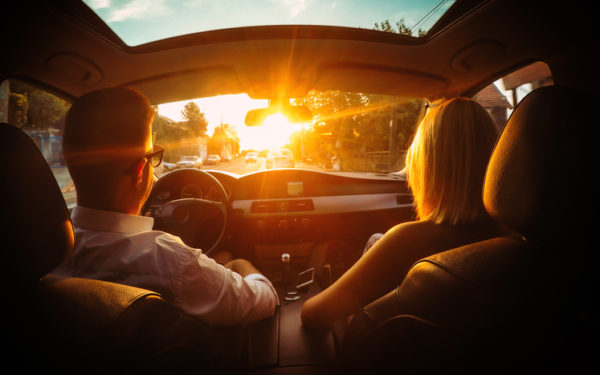 Young couple in a car on the road.