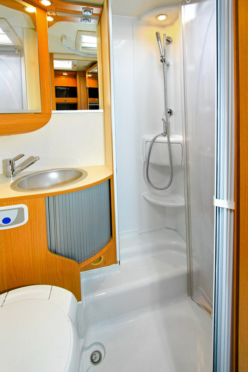 Interior of shower cabin in recreation vehicle.