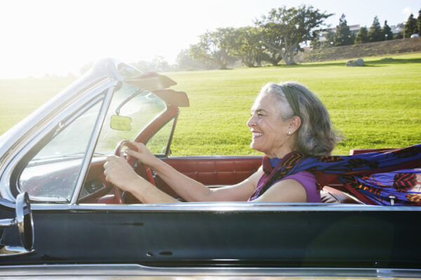 Caucasian woman driving classic convertible