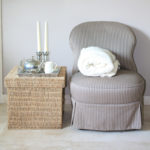 Interior design: Classic Biedermeier chair and wicker footstool, serving tray with silver accessoiries