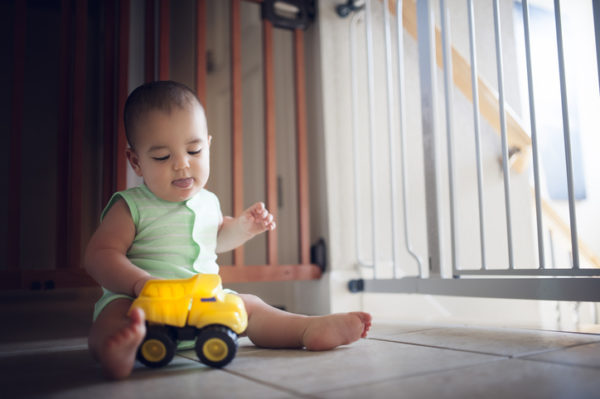 Baby boy plays with his yellow toy truck