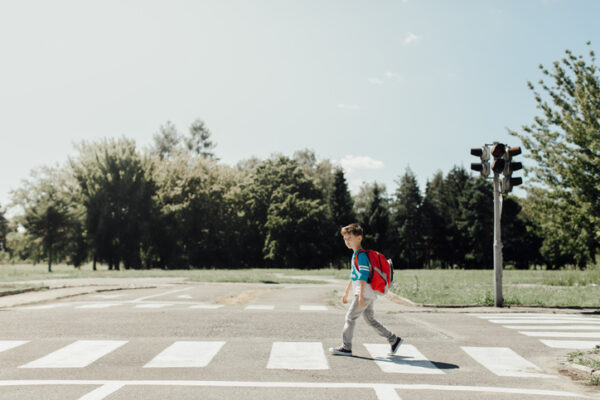Schoolboy crossing a road on his morning way to school