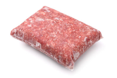 Pack of frozen ground meat isolated on white