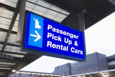 Airport signs for passenger pick up and rental cars