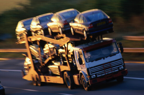 Car transporter with full load, on motorway (blurred motion)