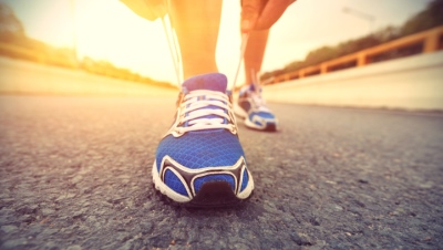 lacing up tennis shoes on a track