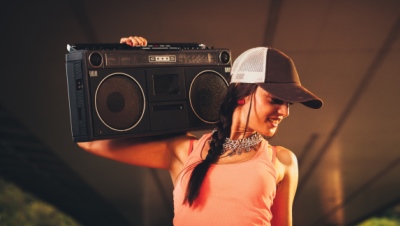 Young woman holding a boom box