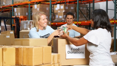 Volunteers Collecting Food Donations In Warehouse