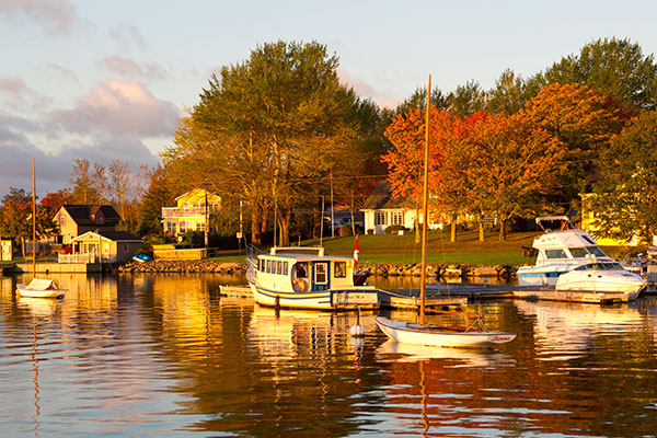 Boats on water with fall foliage