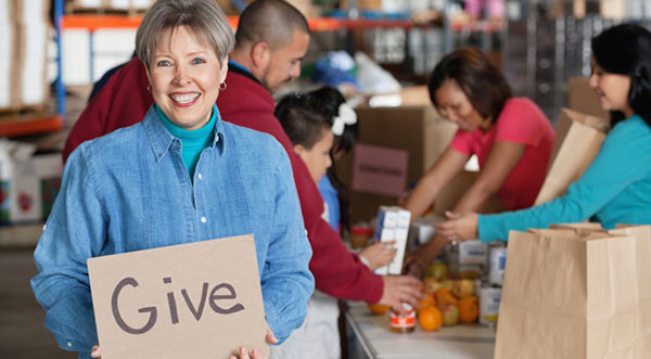 Woman holding a sign that says Give