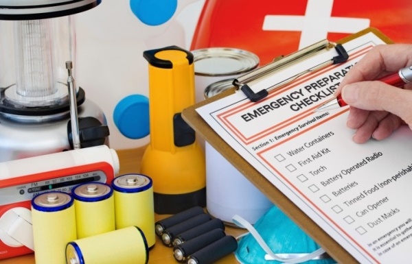 Hand completing Emergency Preparation List by Equipment