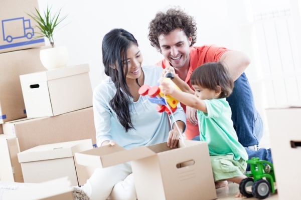 family packing or unpacking moving boxes