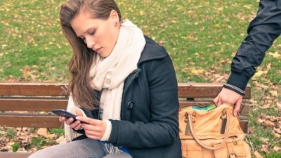 Pickpocketing from the bag of a young woman outdoors