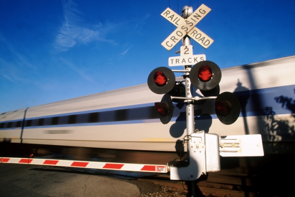 train speeding through railroad crossing