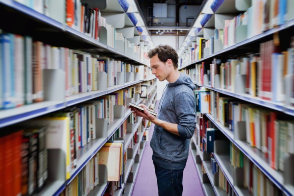 young man browsing through library