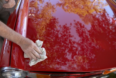 Man Polishing the Hood of His Car