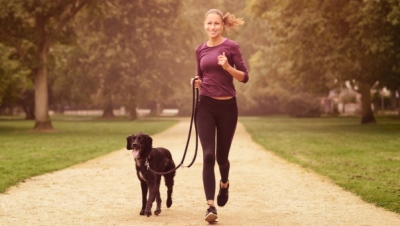 young woman jogging with dog